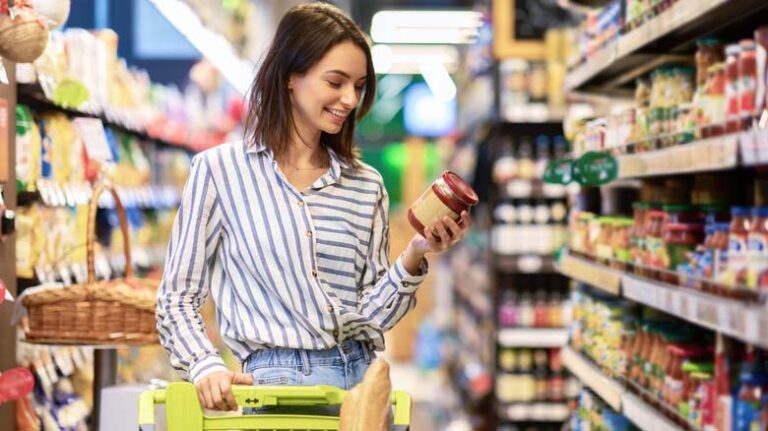 Portrait,Of,Smiling,Woman,With,Shopping,Cart,In,Supermarket,Buying